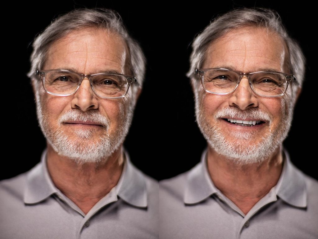 A friendly double expression editorial studio portrait of Thomas Paul with silver hair