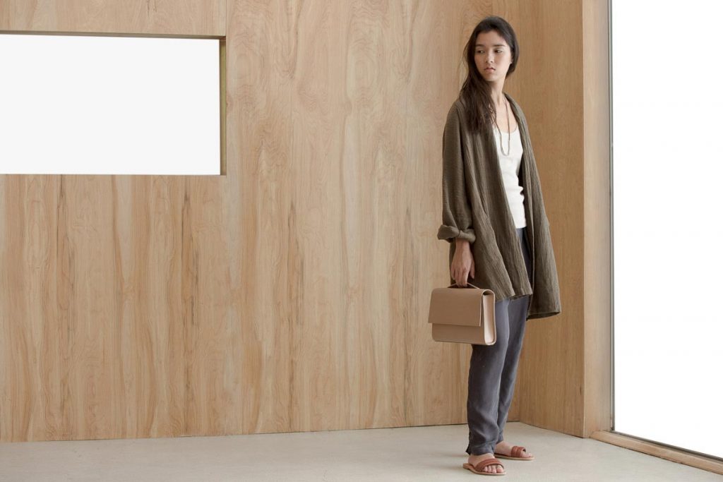 Full length editorial fashion shot of a woman in a bright wooden room by fashion photographer Nick Reid.